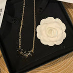 Black Enamel Star Necklace – Triple Stars with Interlocking C