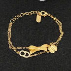 Double Strand Charm Bracelet – Pavé Monogram, Ribbed Bow and Clover