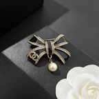 Black Glitter Enamel Bow Brooch – Crystal Edges & Bead Drop